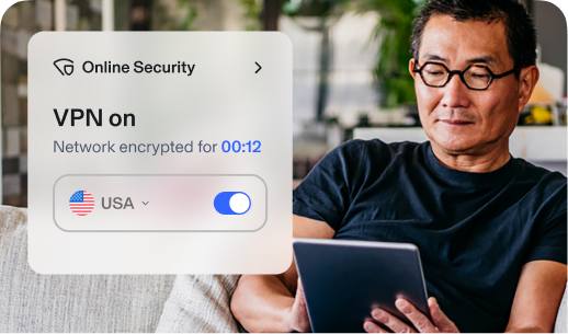 Man using tablet. Aura app overlay says: Online Security. VPN is on and Network has been encrypted for 12 minutes. USA Location is toggled on.