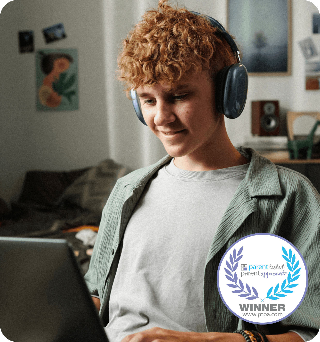Young boy on laptop with headphones on smiling