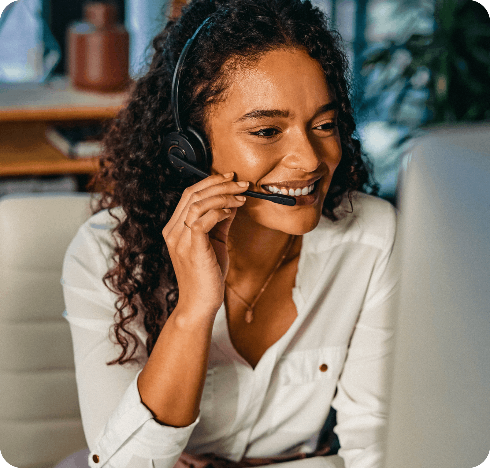 Lady answering call to give best in class fraud support smiling