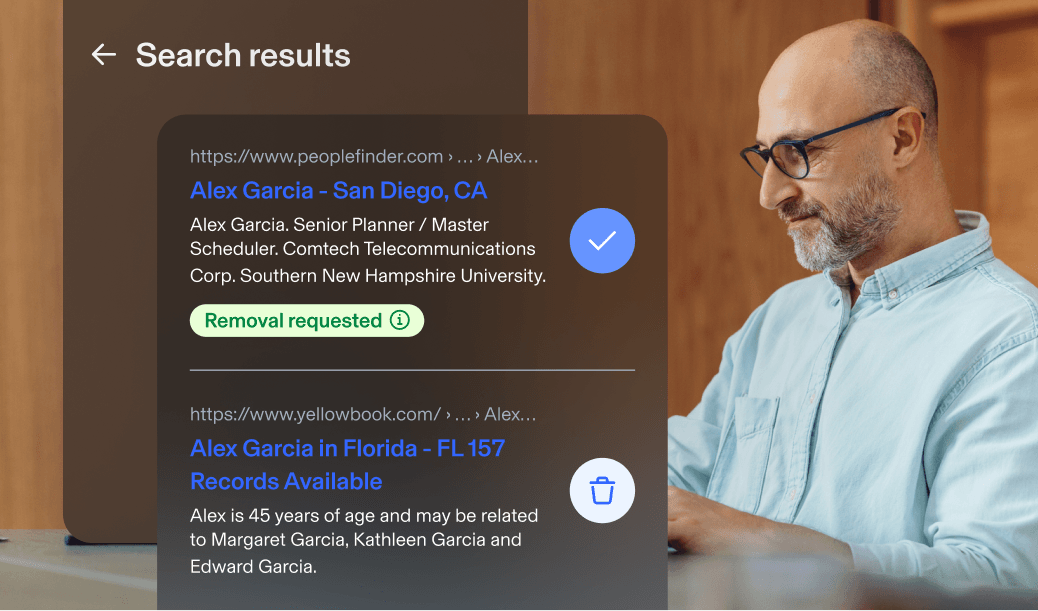 Man using laptop. Aura app popups show search results for Alex Garcia with two results, one in Florida and another in California. One displays a removal requested for Alex Garcia's information from the search engine.