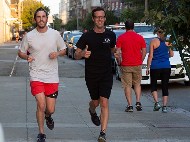 two men running at a meetup event